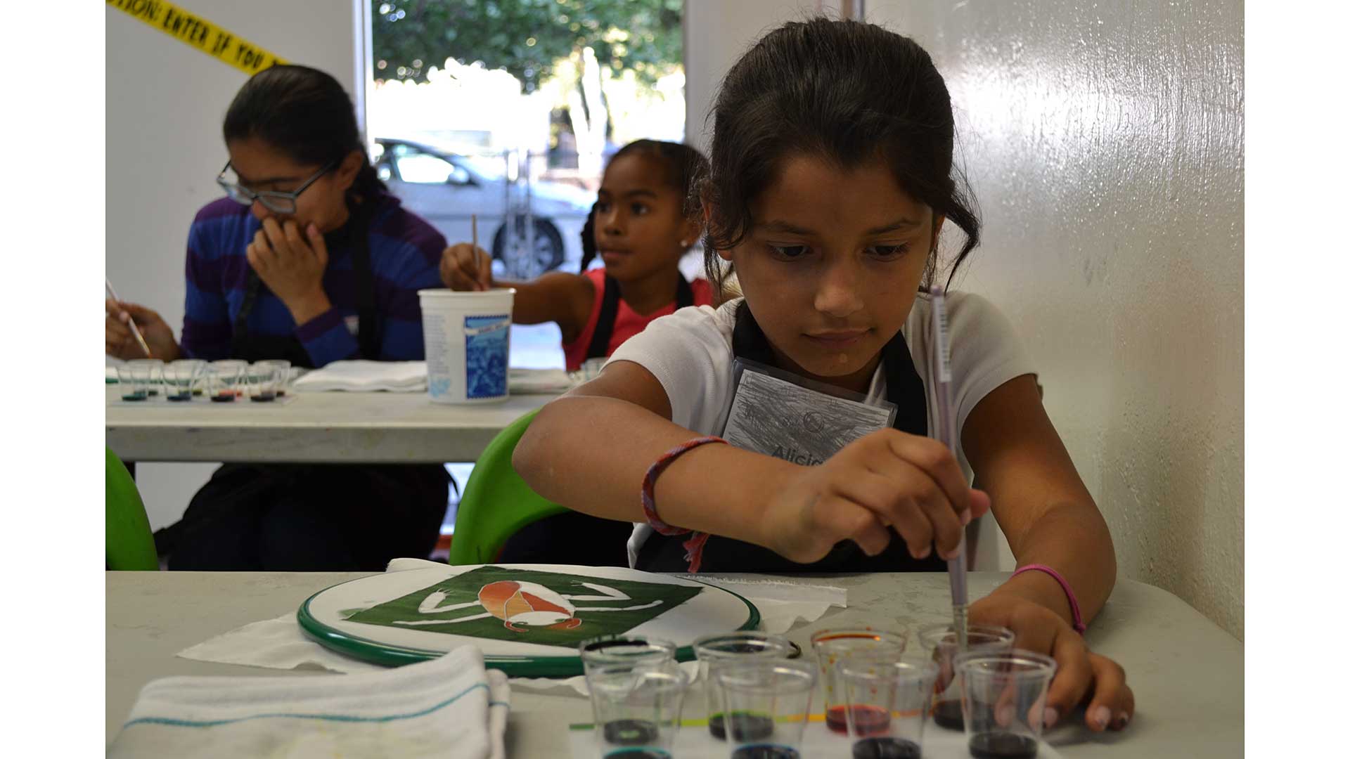 Girls to Women participants painting silk squares