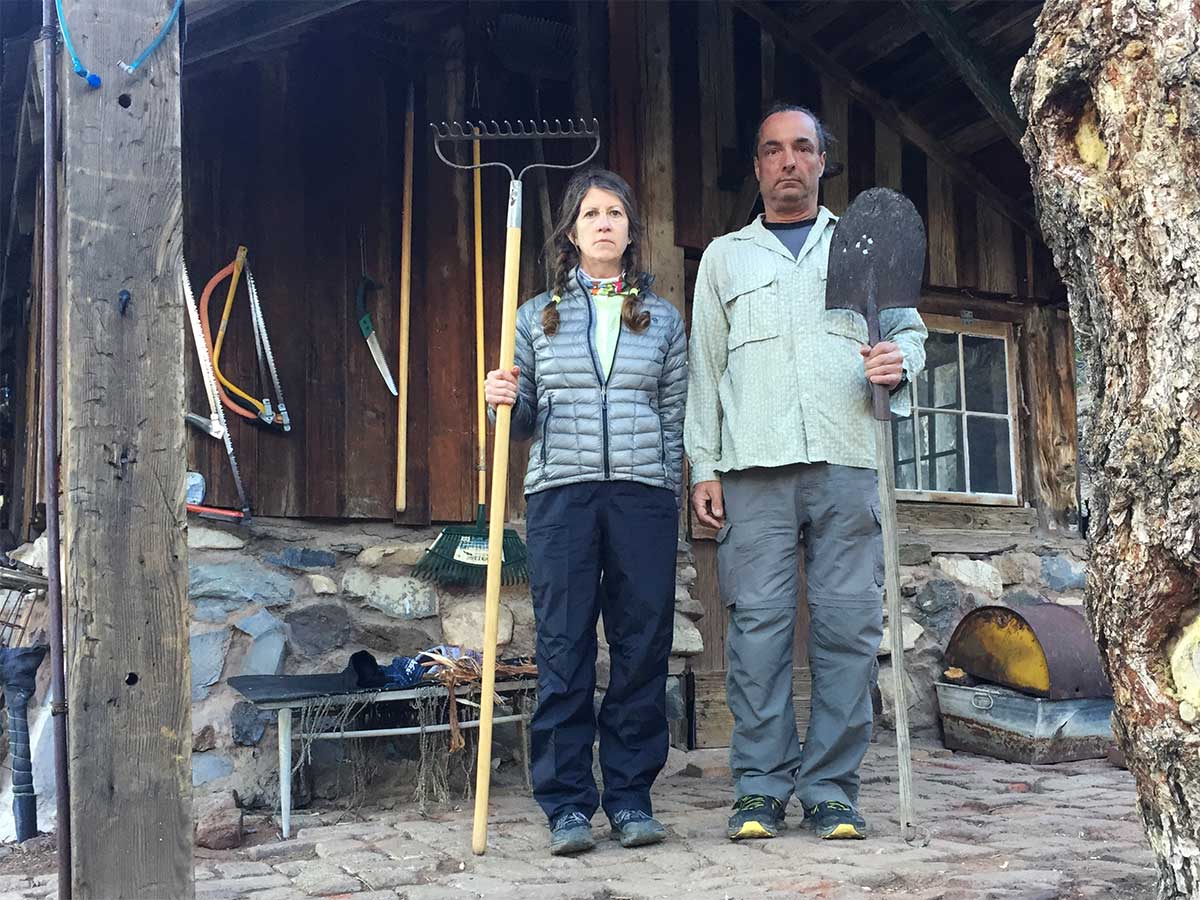 Posing like the American Gothic Painting with gardening tools