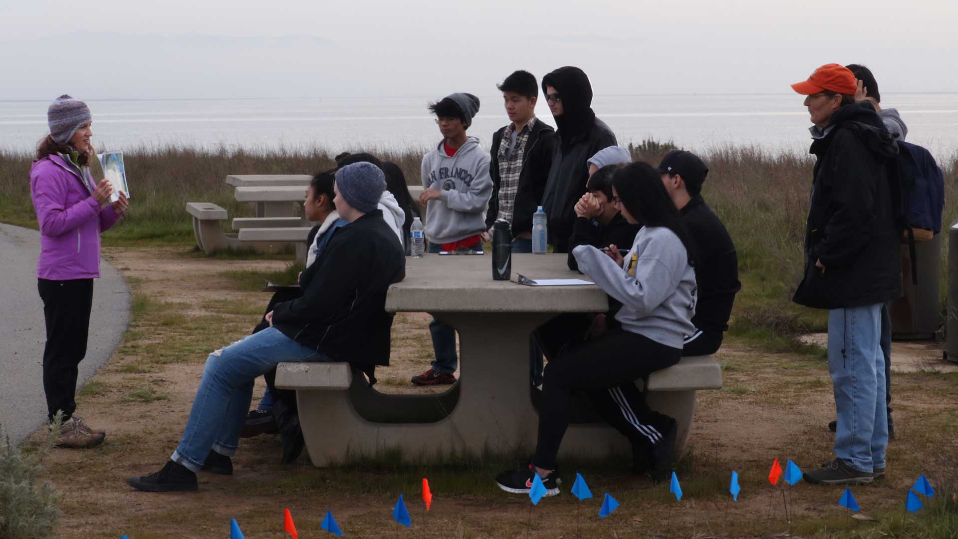 Showing group of high school students the research behind the Living Shoreline Art Installation